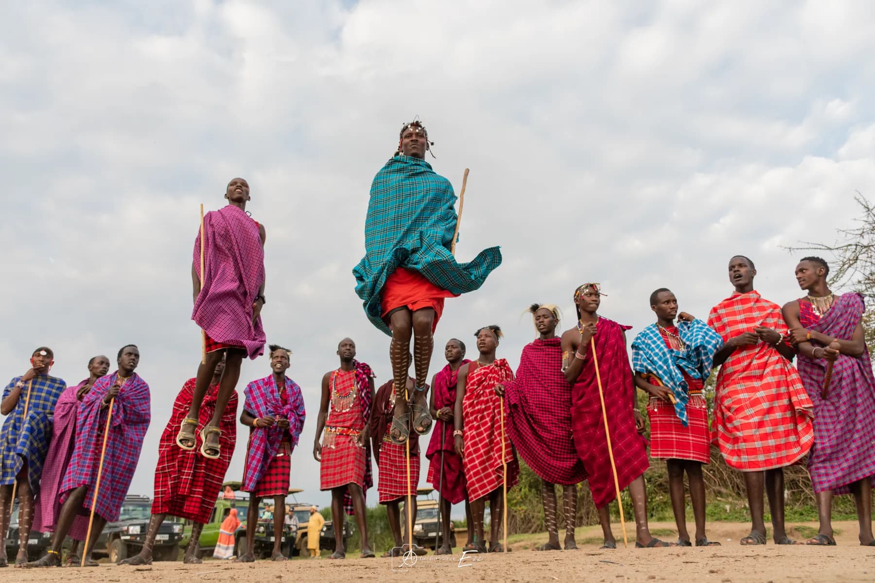 Maasai warriors in red shukas performing the traditional jumping dance