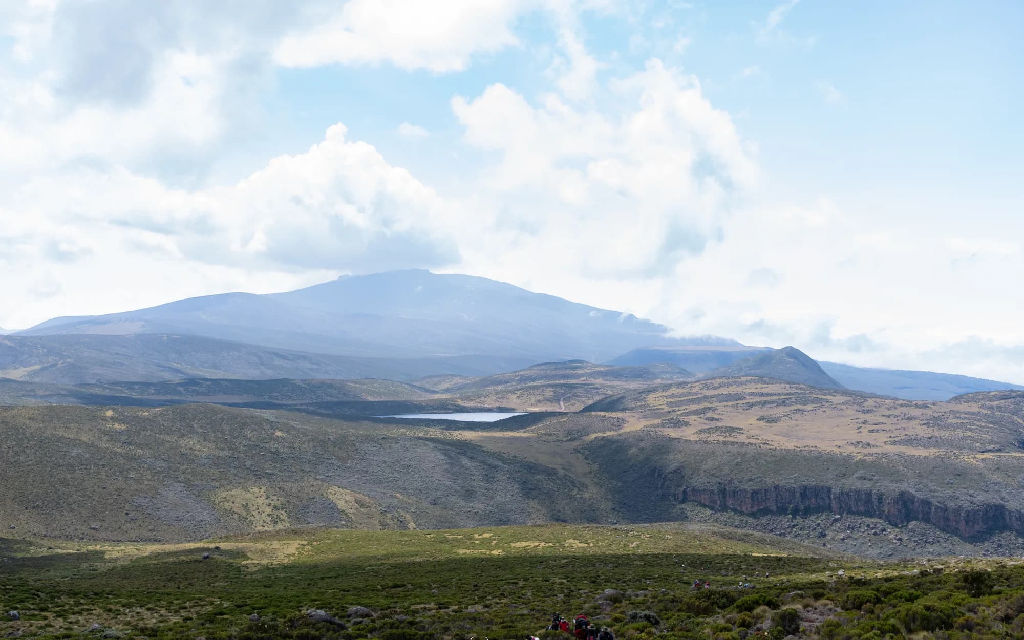 The peaks of Mount Kenya rising beyond the high moorland plateau
