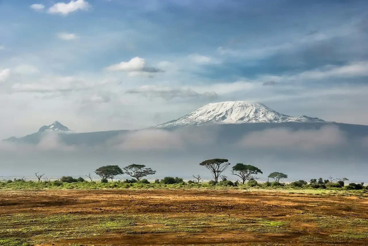 Snow-capped Mount Kilimanjaro rising above the acacia plains of Amboseli
